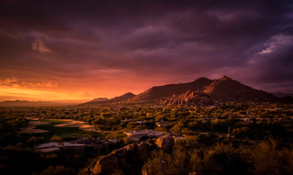 Sunset over the desert mountains and homes of Mesa, Arizona